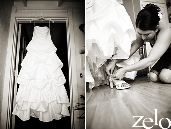 Wedding dress hanging in doorway with bridesmaid helping bride