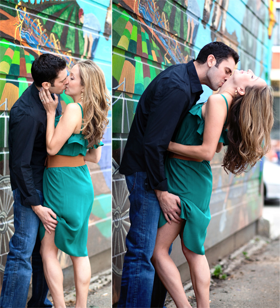 Passionate couple kissing near colorful wall art during photo shoot