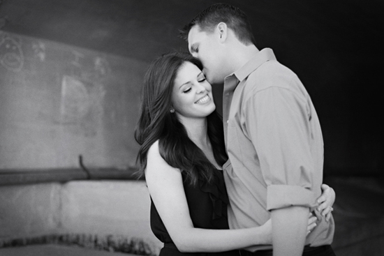 Romantic black and white photo of a couple embracing tenderly, smiling