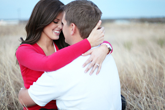 Couple embracing in field