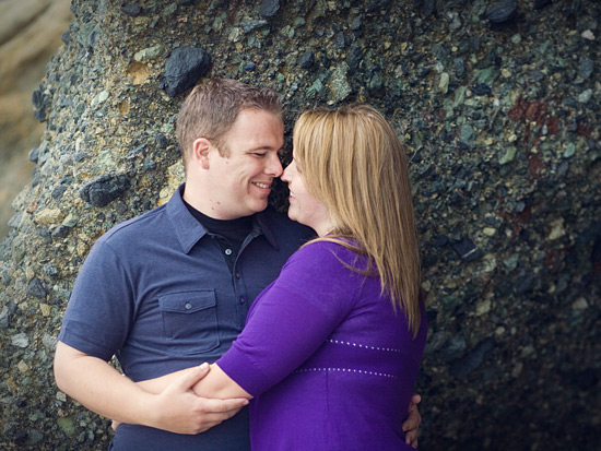 Romantic couple embracing near a rocky shore