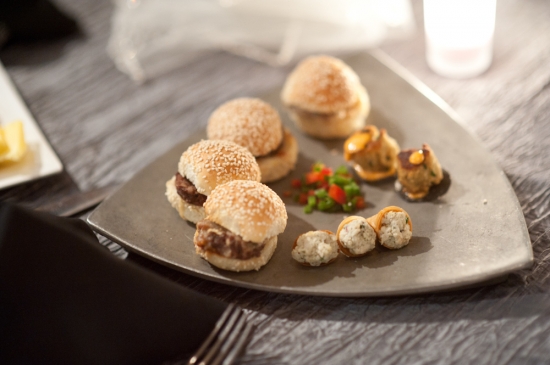 Delicious assorted appetizers on gray triangular plate