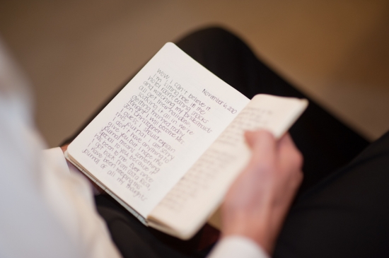 Person reads a handwritten journal entry before event