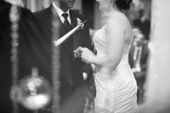 Bride and groom holding hands during their wedding ceremony