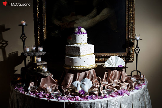 Elegant wedding cake table with candles and decor