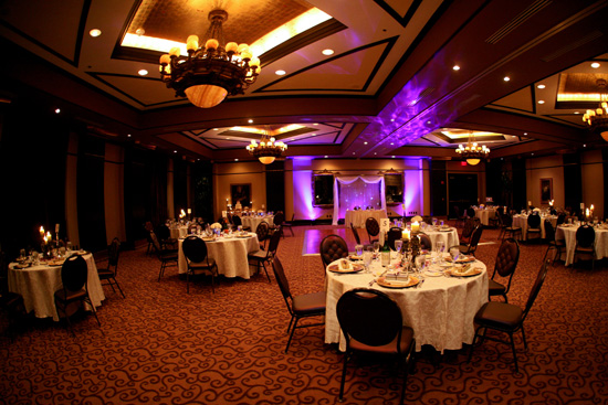 Elegant ballroom decorated for a wedding reception with round tables