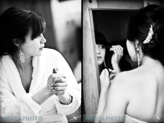 Bride gets ready, applying makeup in a mirror, before wedding