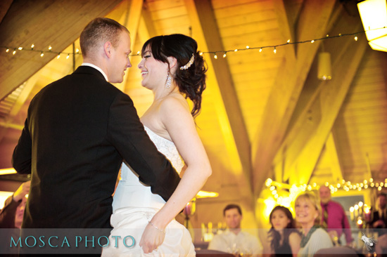 Happy bride and groom share a first dance at their wedding reception