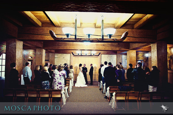 Wedding ceremony taking place inside a beautiful wooden venue