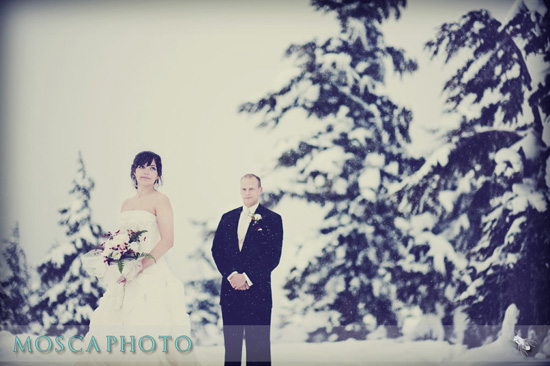 Winter wedding ceremony with bride and groom in snow
