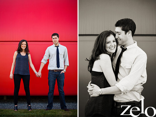 Happy couple holding hands in front of a bright red wall