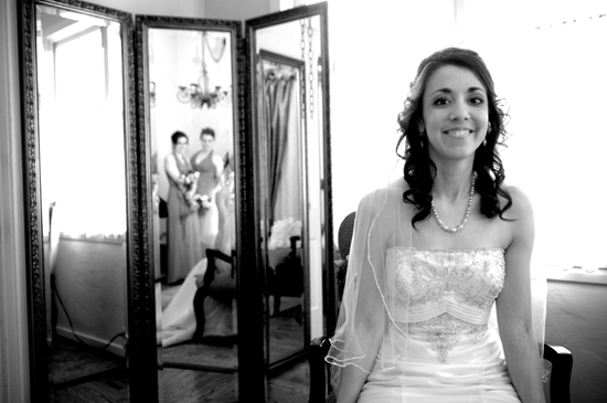 Bride in wedding dress, reflected bridesmaids
