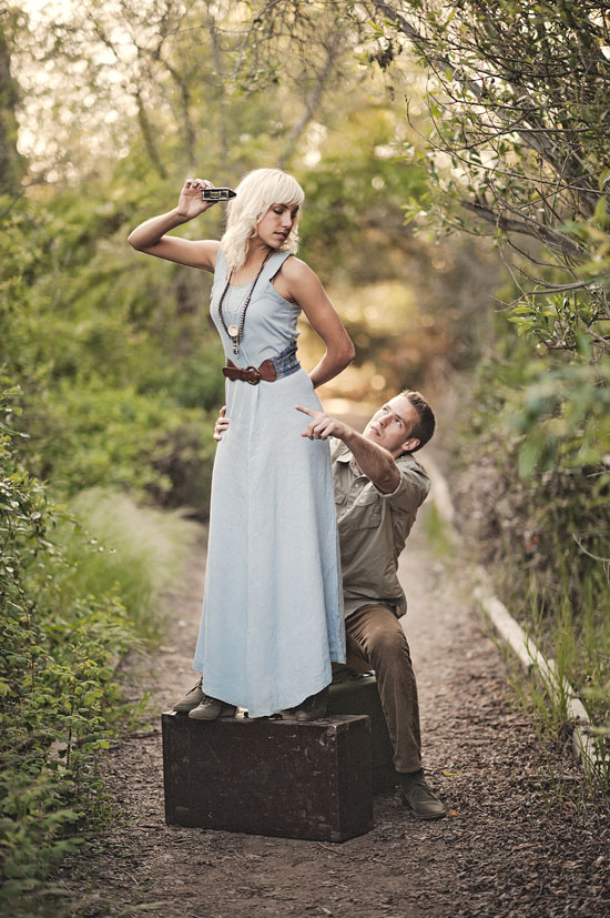 Vintage couple on luggage with camera in nature
