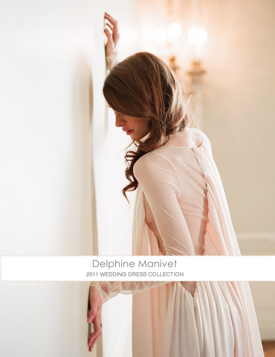 Woman in flowing gown rests against a wall dreamy pose