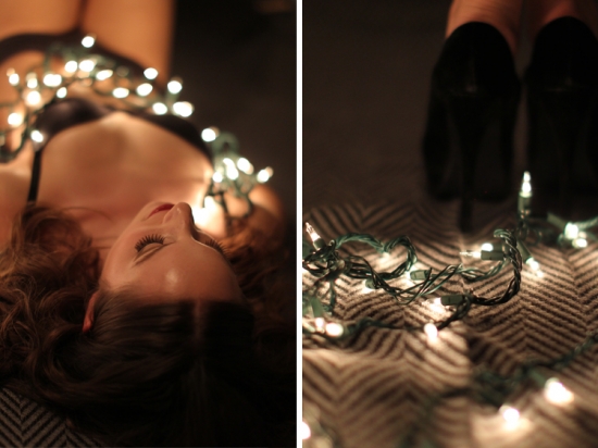 Woman draped in Christmas lights, seductive pose
