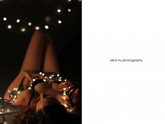 Woman adorned with fairy lights, sensual pose