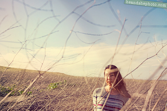 Woman standing in a field of tall grass