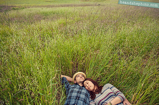 Couple relaxing in tall grass field together outdoors