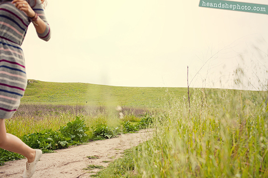 Woman runs on path through grassy field
