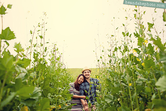 Happy couple embraces in a green field