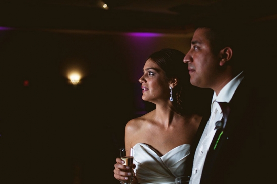 Couple in wedding attire looking on