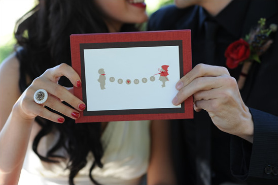 Cute couple holding a wedding invitation card