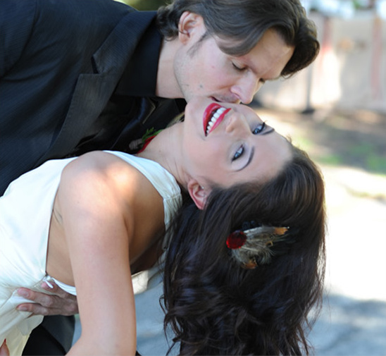 Romantic couple kissing; bride in white dress