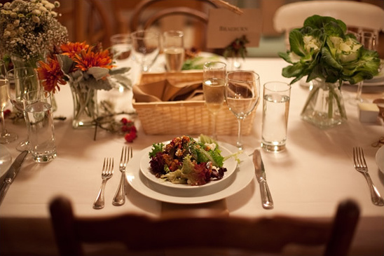 Festive table setting with salad and floral decorations