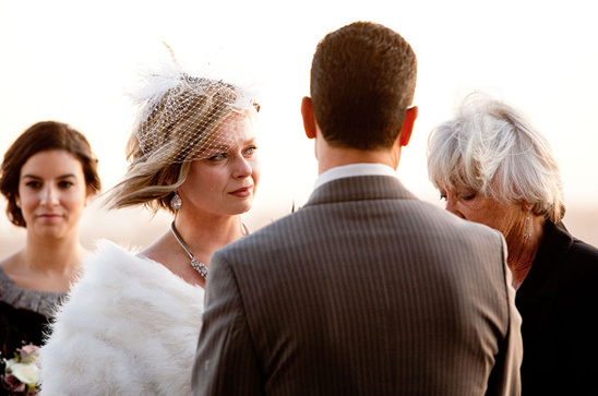 Bride gazes lovingly at groom during wedding ceremony