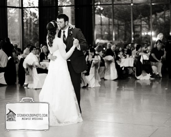Bride and groom share a first dance kiss at wedding reception