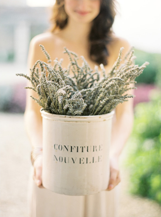 Woman holding a pot of lavender with Confiture Nouvelle written