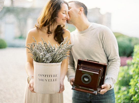 Romantic couple with lavender and vintage camera enjoying life