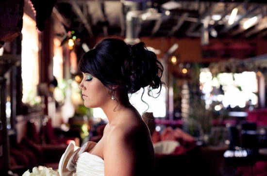 Bride with elegant updo, wearing white dress