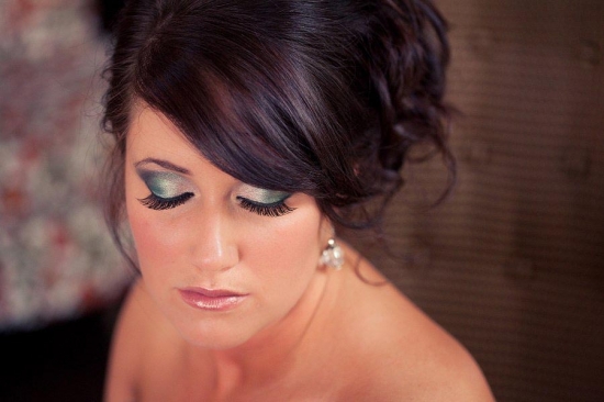 Stunning bridal makeup featuring teal eyeshadow and soft pink lips