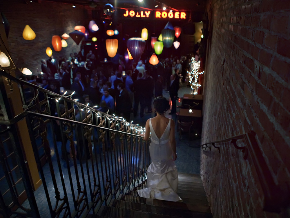 Bride descends staircase at Jolly Roger wedding reception