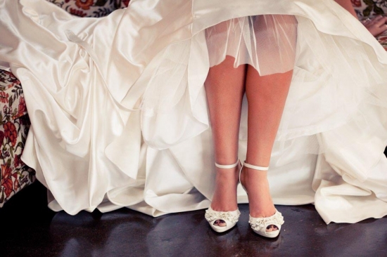 Bride's elegant white satin wedding shoes