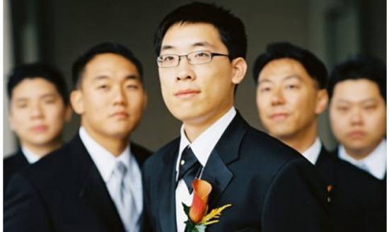 Groom with groomsmen in tuxedos at wedding