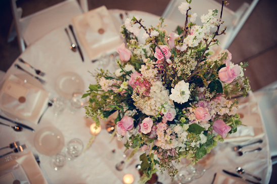 Elegant pink and white floral centerpiece adorns wedding table
