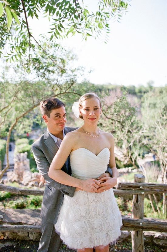Couple embracing in wedding dress outdoors