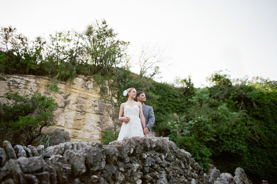 Couple in wedding attire on a rocky outcrop