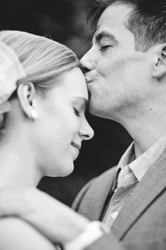 Groom kisses bride on forehead wedding moment
