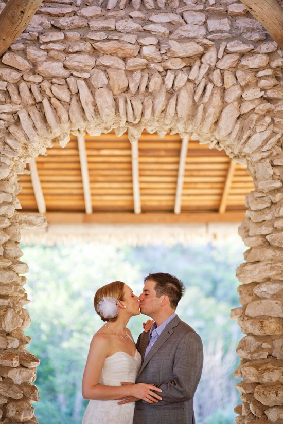 Couple kissing under stone archway