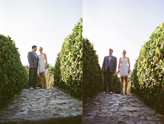 Couple in wedding attire on a stone path