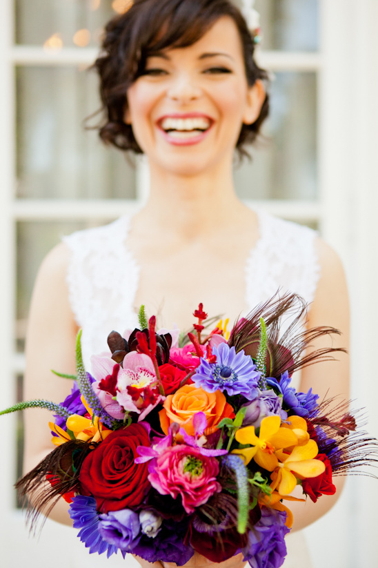 Happy bride with colorful wedding flower bouquet
