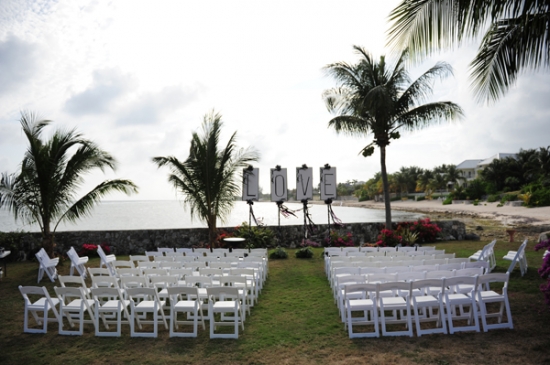 Beach wedding ceremony setup with LOVE sign