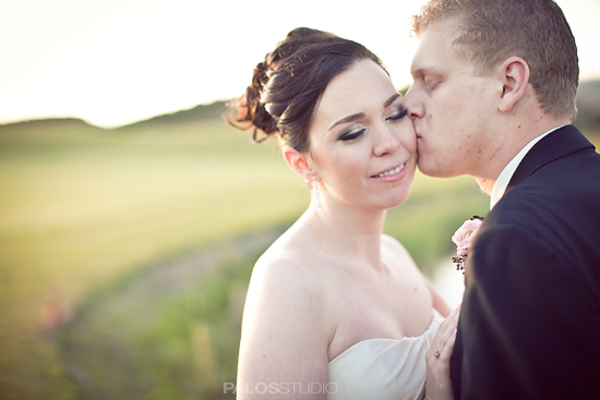 Couple kissing outdoors at wedding