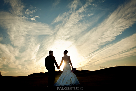 Couple holding hands sunset wedding photo