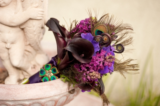 Elegant purple wedding bouquet with peacock feathers