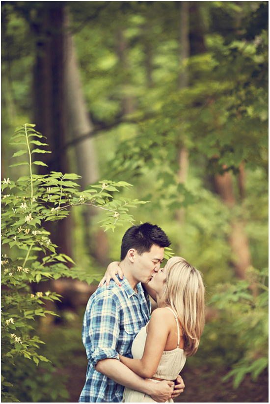 Couple kissing in the woods on their wedding day