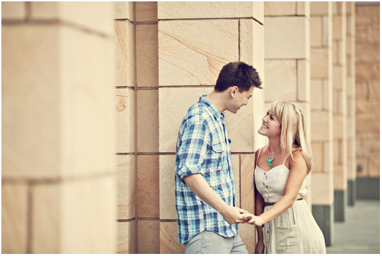 Couple holding hands smiling at each other outside